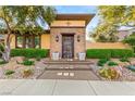 Inviting front entrance with stone accents, landscaped pathway and succulent plants at 2369 Green Mountain Ct, Las Vegas, NV 89135