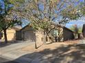 Inviting single-story home with desert landscaping, and mature tree at 3388 Old Course St, Las Vegas, NV 89122