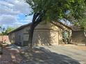 Attractive single-story home featuring a spacious driveway with desert landscaping at 3388 Old Course St, Las Vegas, NV 89122