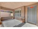 Inviting covered front porch with stone columns and a gray front door at 3618 Auckland Castle St, Las Vegas, NV 89135