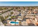 An elevated aerial view reveals a pool, mature palms, and neighborhood landscape with mountain views at 3708 Calumet Farm Cir, North Las Vegas, NV 89031