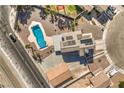 Aerial view showcases the backyard pool and spa, a modern roof with solar panels, and ample parking space at 3708 Calumet Farm Cir, North Las Vegas, NV 89031