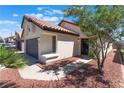 Lovely single-story home boasts terracotta roof, rock landscaping, and a stucco exterior at 4149 Compass Rose Way, Las Vegas, NV 89108