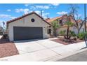 Charming single-story home featuring a terracotta roof, gray garage door, and desert landscaping at 4149 Compass Rose Way, Las Vegas, NV 89108