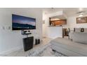Inviting living room with a large flat-screen TV, cozy sofa, and view of the kitchen and dining area at 4200 S Valley View Blvd # 1074, Las Vegas, NV 89103