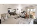 Relaxing living room with a sofa, treadmill, and sliding glass door to a balcony at 4200 S Valley View Blvd # 1074, Las Vegas, NV 89103