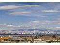 Scenic view of the Las Vegas skyline and surrounding mountains under a bright, cloudy sky at 440 N Lisbon St, Henderson, NV 89015