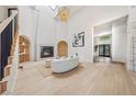 Bright living room with fireplace, vaulted ceilings, modern staircase, and lots of natural light at 5741 S Pearl St, Las Vegas, NV 89120