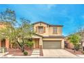 Inviting two-story home with a well-manicured front yard and attached two car garage at 6554 Macdoogle St, Las Vegas, NV 89166