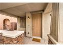 Inviting front entrance with a classic door, complemented by stone accents and an ambient outdoor light at 6554 Macdoogle St, Las Vegas, NV 89166