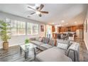 Bright living room with a modern sectional sofa, open floorplan and hardwood floors at 6554 Macdoogle St, Las Vegas, NV 89166