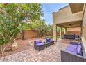 Charming outdoor patio with brick pavers and comfortable seating area, plus a hot tub for relaxation at 6554 Macdoogle St, Las Vegas, NV 89166