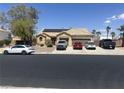 Charming single-story home featuring a tile roof, solar panels, desert landscaping, and a multi-car driveway at 6596 Secluded Ave, Las Vegas, NV 89110