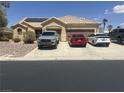 Inviting single-story home featuring a tile roof, solar panels, desert landscaping, and a multi-car driveway at 6596 Secluded Ave, Las Vegas, NV 89110