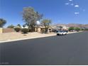 Inviting single-story home with desert landscaping and views of mountains in the distance at 6596 Secluded Ave, Las Vegas, NV 89110