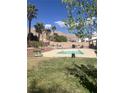 Beautiful in-ground swimming pool surrounded by lush greenery and a spacious patio area, ideal for summer fun at 6596 Secluded Ave, Las Vegas, NV 89110