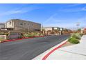 Community entrance with manicured landscaping, wooden fence and clear signage on a sunny day at 6626 Evander St, North Las Vegas, NV 89086
