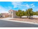 View of a two-story home with a red tile roof and neutral stucco exterior, featuring a long driveway at 6715 Maple Mesa St, North Las Vegas, NV 89084