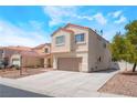 Side exterior view of a charming two-story home with neutral stucco and a red tile roof, spacious driveway at 6715 Maple Mesa St, North Las Vegas, NV 89084