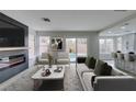 Inviting living room with a fireplace, a view of the pool and a sliding door at 71 Sea Holly Way, Henderson, NV 89074
