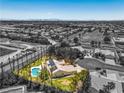 An aerial view of the home featuring a backyard pool, solar panels and lush landscaping in a lovely community at 7300 Breezy Night Ct, Las Vegas, NV 89129