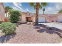 Attractive single-story home featuring desert landscaping, tile roofing, and a two-car garage at 7909 Sierra Rim Dr, Las Vegas, NV 89131