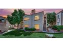Charming multi-Gathering home with lush lawn, mature trees, and beautiful sunset lighting at 8408 White Eagle Ave # 101, Las Vegas, NV 89145