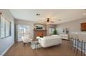 Bright living room with hardwood floors, fireplace, and sliding door access at 8728 Tom Noon Ave # 103, Las Vegas, NV 89178