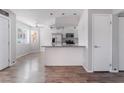 Modern kitchen featuring stainless steel appliances, breakfast bar and open layout to the living room at 912 Falconhead Ln # 101, Las Vegas, NV 89128