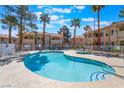 Community pool and spa offers a refreshing escape with ample lounge seating under the sunny sky at 912 Falconhead Ln # 101, Las Vegas, NV 89128