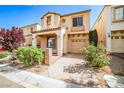 Inviting two-story home with a warm stucco exterior and landscaped front yard with driveway and attached garage at 9717 Villa Lorena Ave, Las Vegas, NV 89147