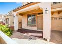 Covered porch with brick detail, columns, and an overhead light, leading to the front door and attached garage at 9717 Villa Lorena Ave, Las Vegas, NV 89147
