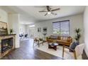 Bright living room featuring a sleek fireplace, modern furniture, neutral colors, and natural light at 9966 Mystic Moss St, Las Vegas, NV 89183