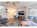 Comfortable living room with wood floors, a ceiling fan, and lots of natural light at 1041 Grand Cerritos Ave, Las Vegas, NV 89183