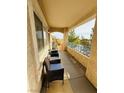 Inviting covered balcony featuring comfortable seating, offering a relaxing outdoor space with beautiful landscape view at 10553 Pine Glen Ave # 202, Las Vegas, NV 89144