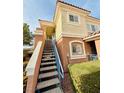 Well-maintained condo building exterior featuring stairs to upper units and manicured landscaping for curb appeal at 10553 Pine Glen Ave # 202, Las Vegas, NV 89144