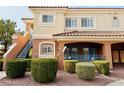 Well-maintained two-story condo building with lush landscaping, mature bushes, and convenient stairs to upper units at 10553 Pine Glen Ave # 202, Las Vegas, NV 89144