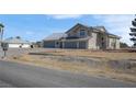 Wide exterior angle of a two story stucco home with a three car garage at 1581 Cavalry St, Pahrump, NV 89048