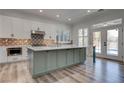Bright kitchen features a large island, stainless appliances, and French doors at 1790 Castro Hill Ave, Henderson, NV 89012
