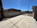 Spacious backyard featuring a concrete patio and block wall, offering privacy and potential for landscaping at 1908 Palmer St, North Las Vegas, NV 89030