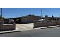 Modest home featuring a simple facade, concrete driveway, and a low block wall bordering the property at 1908 Palmer St, North Las Vegas, NV 89030