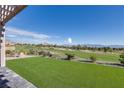Landscaped backyard with synthetic grass and beautiful golf course views at 2024 Bay Tree Dr, Las Vegas, NV 89134