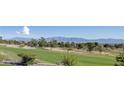Scenic view of the well-manicured golf course, including sand traps and distant mountain views at 2024 Bay Tree Dr, Las Vegas, NV 89134