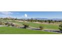 Picturesque golf course view with lush green fairways and mountain backdrop provides a serene outdoor experience at 2024 Bay Tree Dr, Las Vegas, NV 89134