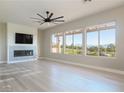 Bright living room with fireplace, ceiling fan and a view of the golf course at 2024 Bay Tree Dr, Las Vegas, NV 89134