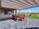 Outdoor patio with shaded pergola and a table with chairs, perfect for entertaining at 2024 Bay Tree Dr, Las Vegas, NV 89134