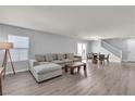 Spacious living room with grey walls, wood flooring, and modern furnishings offers a comfortable gathering space at 2116 Via Firenze, Henderson, NV 89044