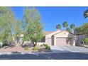 Charming single-story home with a three-car garage and well-maintained landscaping at 2132 Twin Falls Dr, Henderson, NV 89044