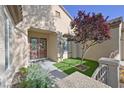 Inviting front entrance with beautiful double doors, artificial lawn, and attractive landscaping at 2132 Twin Falls Dr, Henderson, NV 89044