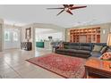 Spacious living room featuring a large leather sofa, stylish rug, and open layout at 2132 Twin Falls Dr, Henderson, NV 89044